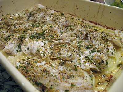 A close up photo of baked striped bass in a baking pan.