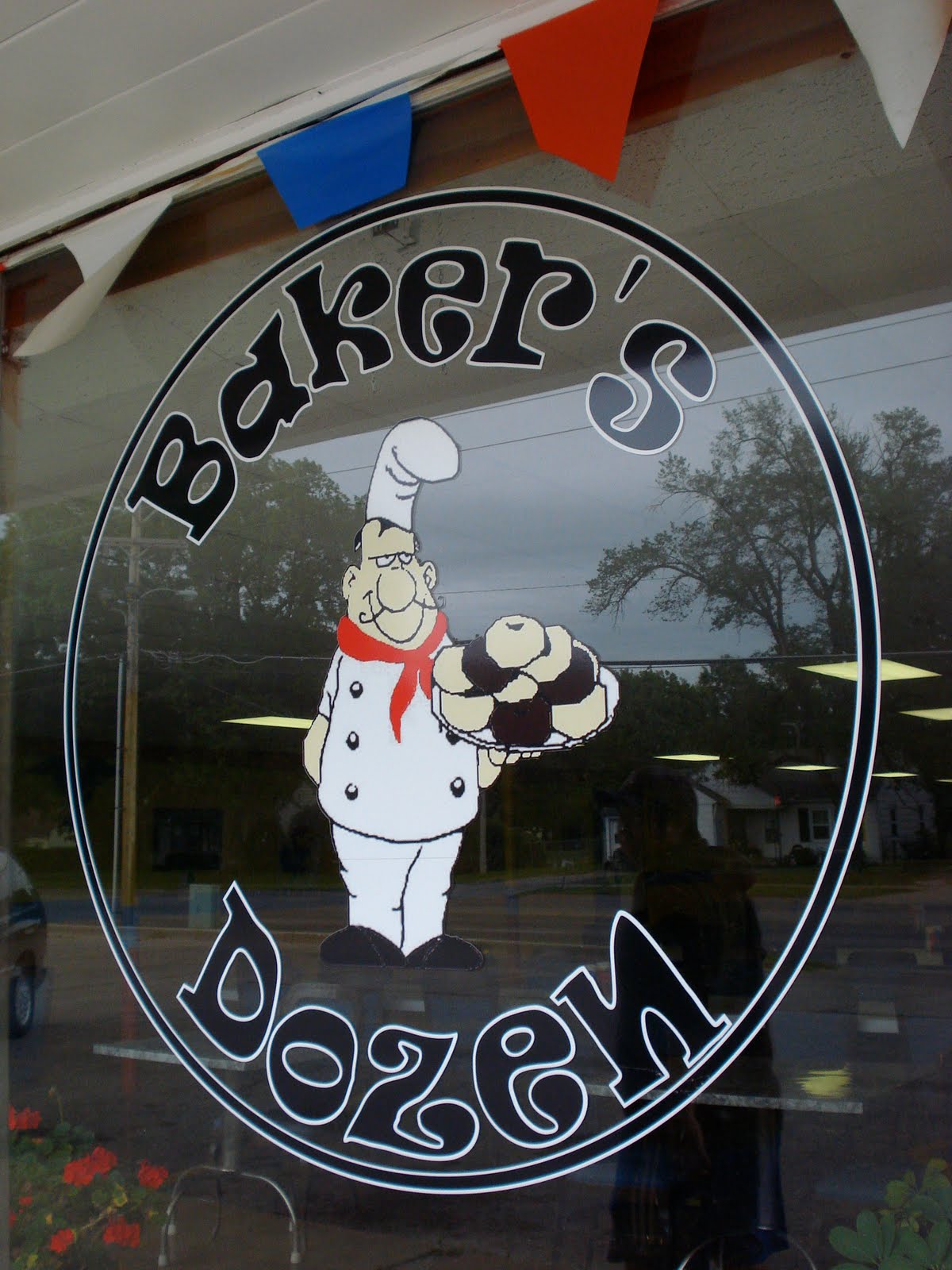 Penguin Eats Baker's Dozen Donuts Topeka, Kansas