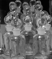 Photograph of several small apothecary bottles.