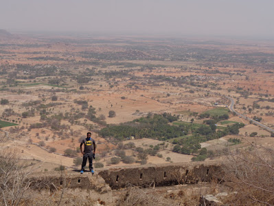 Madhu on the summit of medigeshi, the land in the background can be seen scorched and dry to the bone