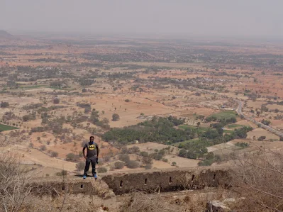 Madhu on the summit of medigeshi, the land in the background can be seen scorched and dry to the bone